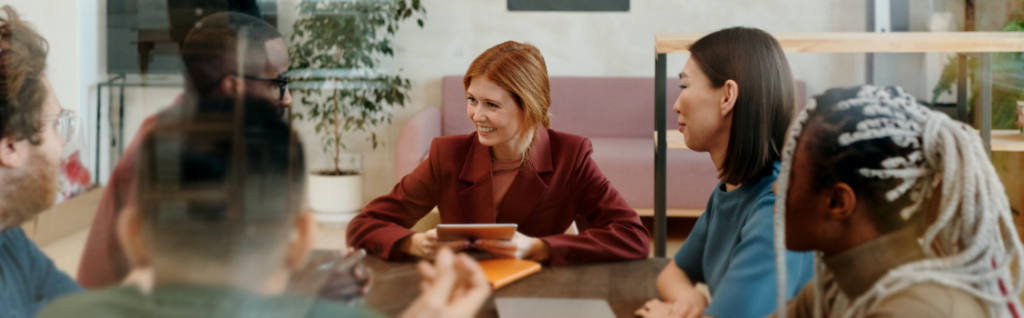 Group of people talking round a table