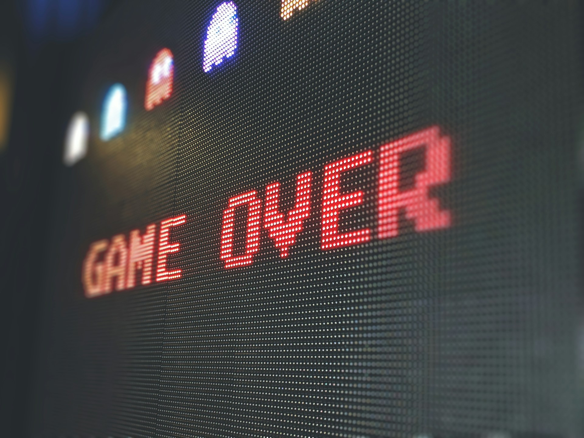 Close-up on a video game screen that reads ' Game over'