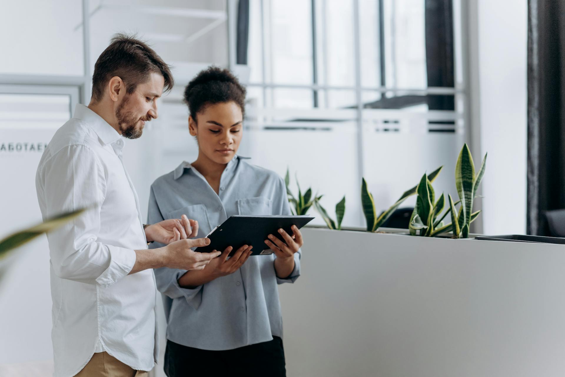 A man and a woman standing together. Photo by Mikhail Nilov on Pexels