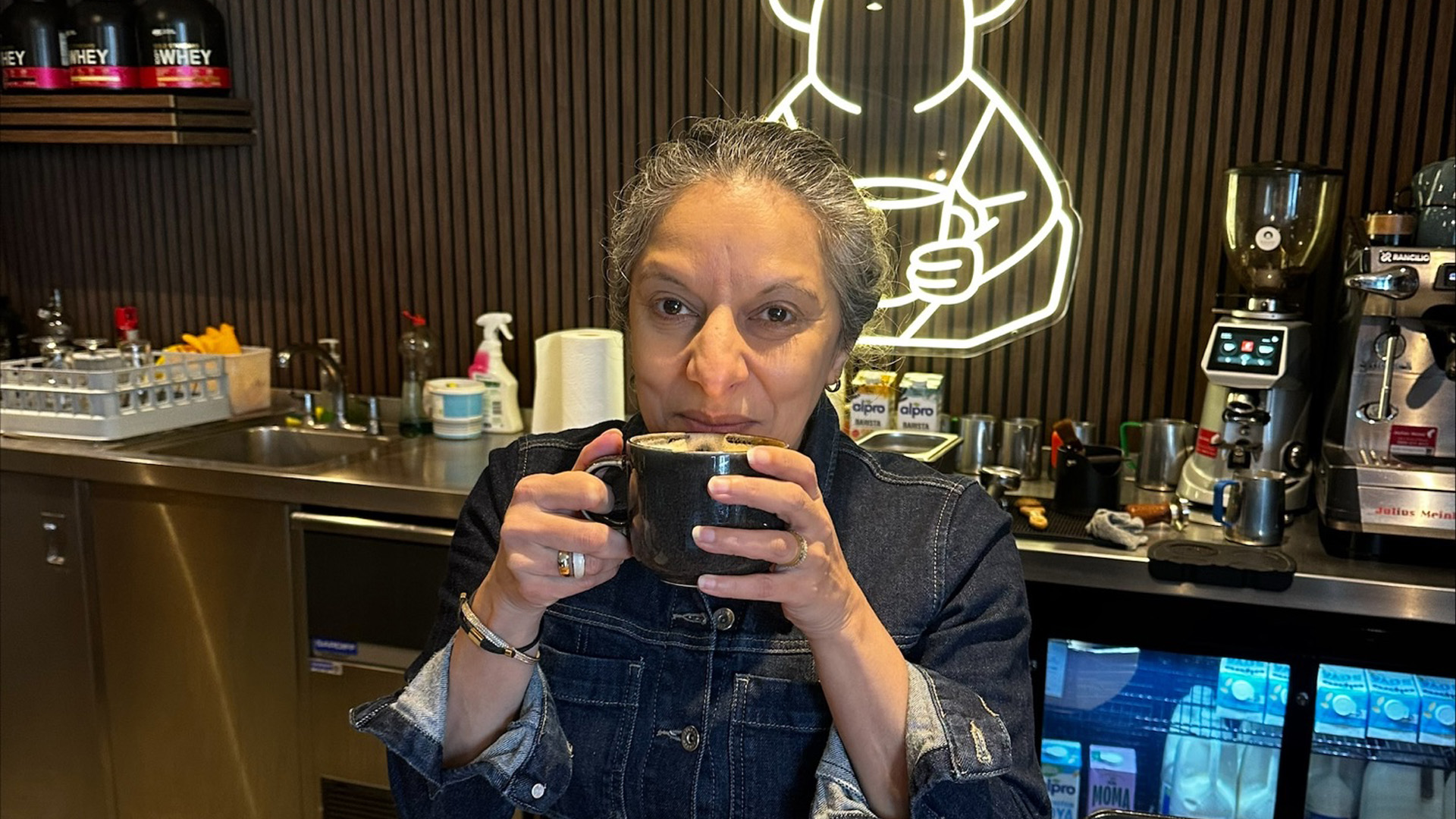 Yogita Popat drinking coffee in a coffee shop