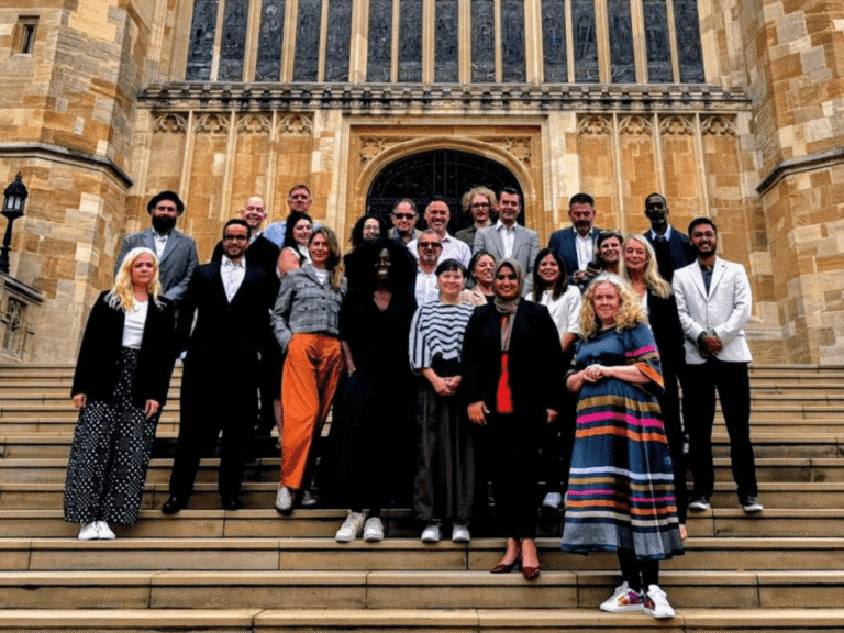 Group of people standing on the steps outside St George's Chapel Windsor.